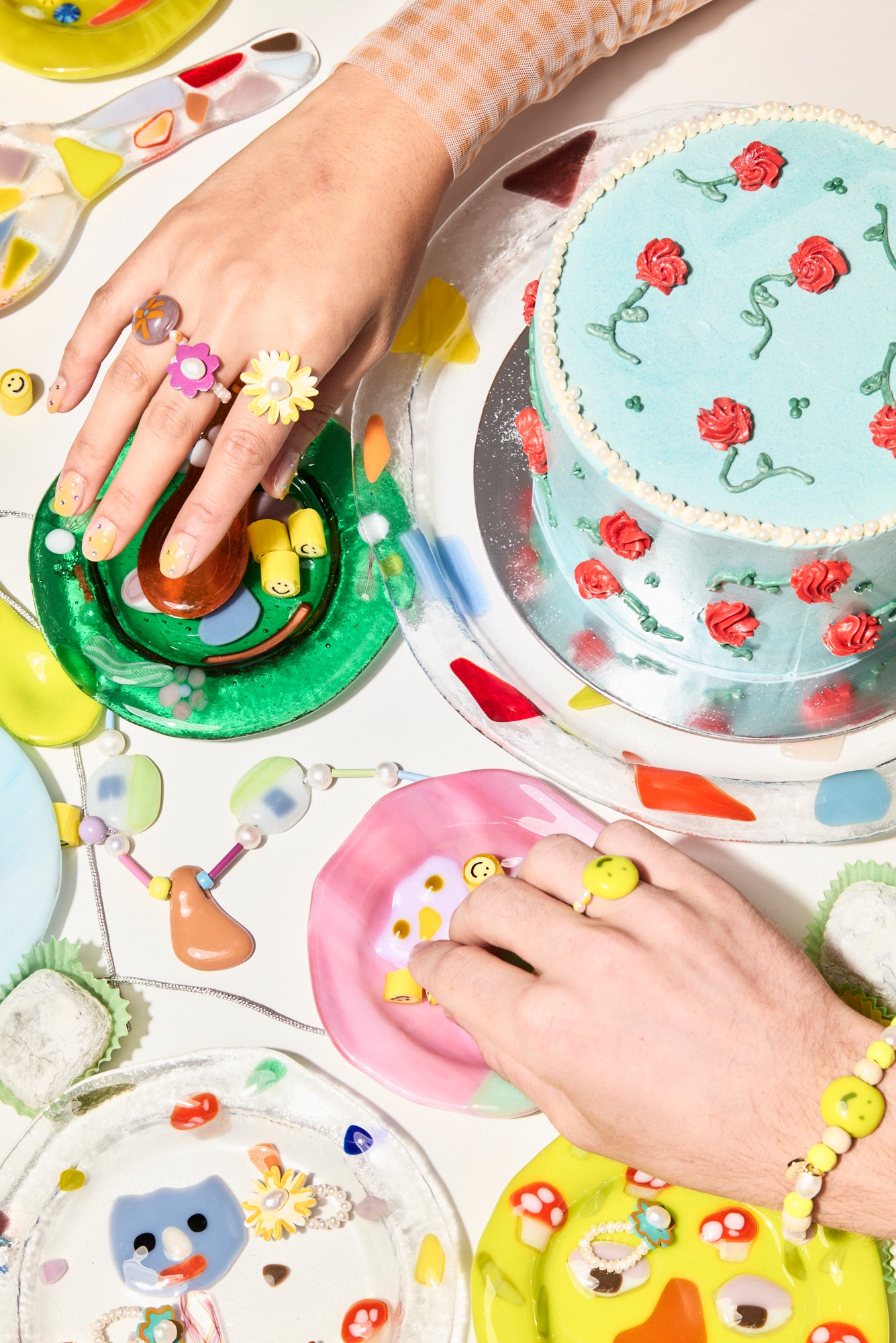 Tablescape of Models Hands Wearing Jewellery Bianca Mavrick x Lawn Bowls Daisy Pearl Glass Ring