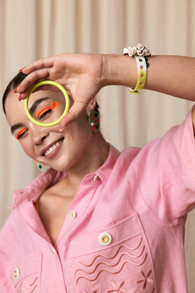 Bianca Mavrick Jewellery Model holding Colore Bangle in Chartreuse