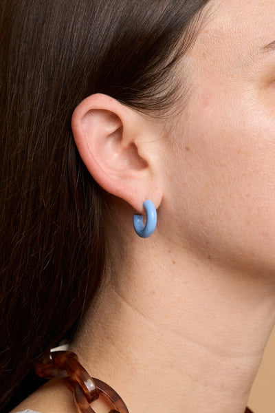 Earlobe with a singular Bianca Mavrick Jewellery powder blue enamel hoop earring